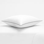 White pillow with a thin black line on a white background, featuring the Razzai brand.
