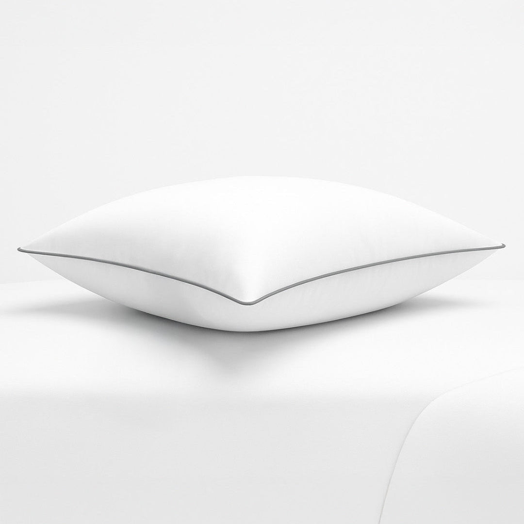 White pillow with a thin black line on a white background, featuring the Razzai brand.