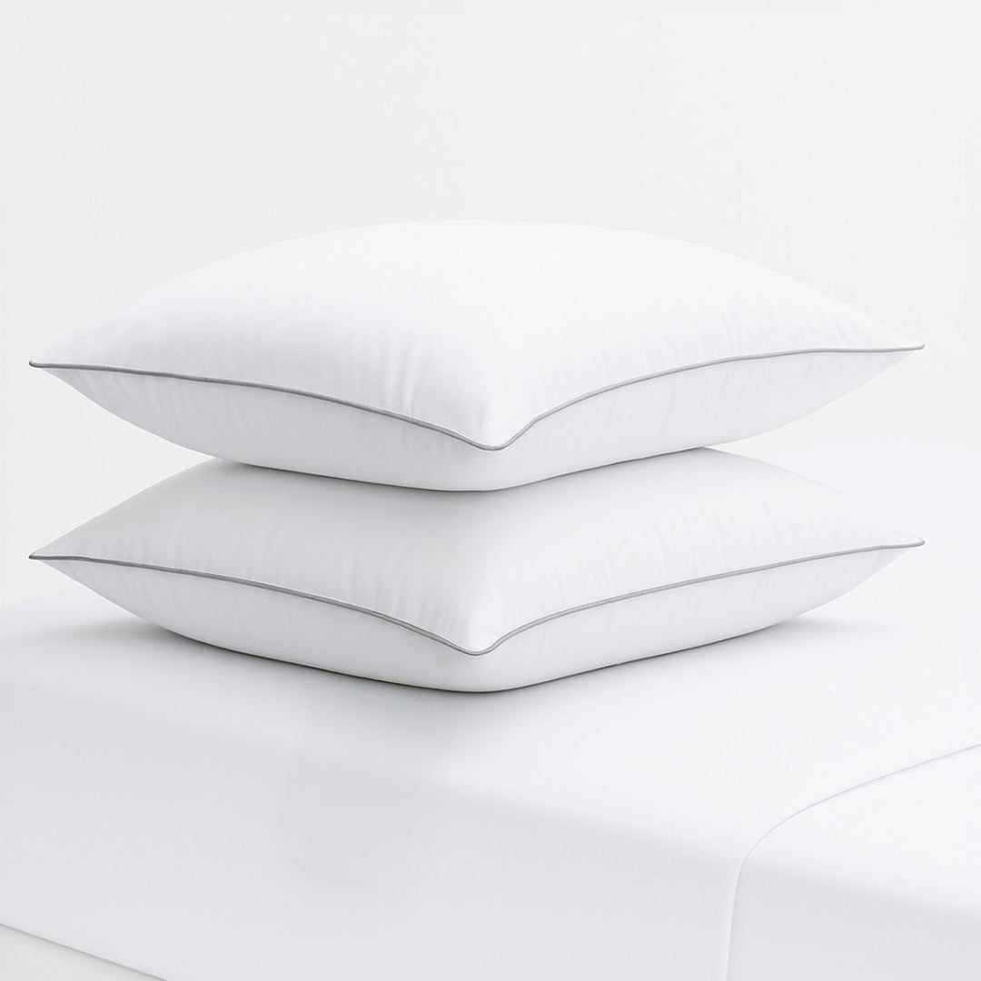 Two white pillows with a thin black line on a white background, featuring the Razzai brand logo.