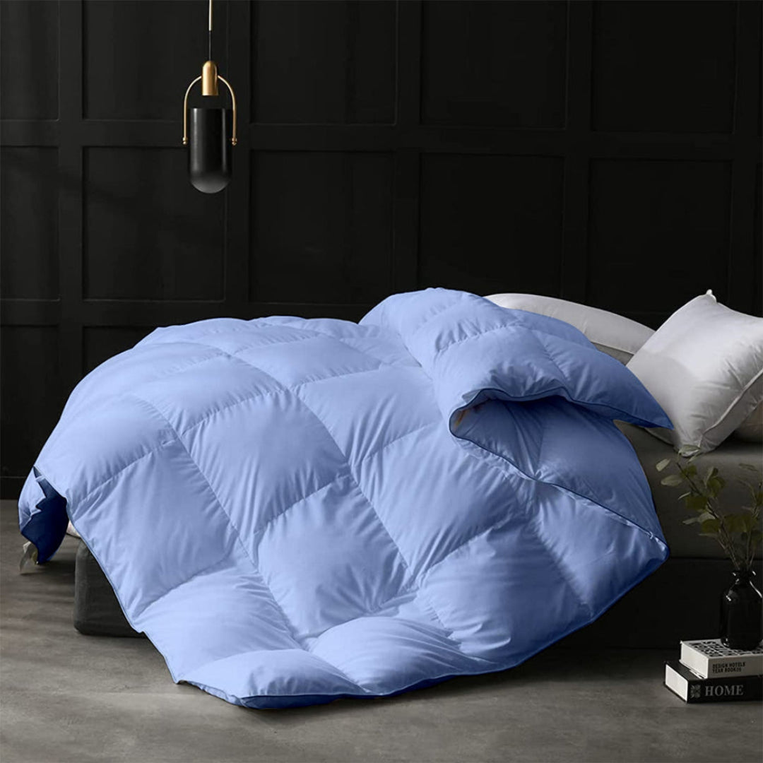 Blue quilt on a bed in a darkly decorated room